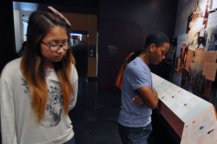 Teens read display material at African American Art Museum